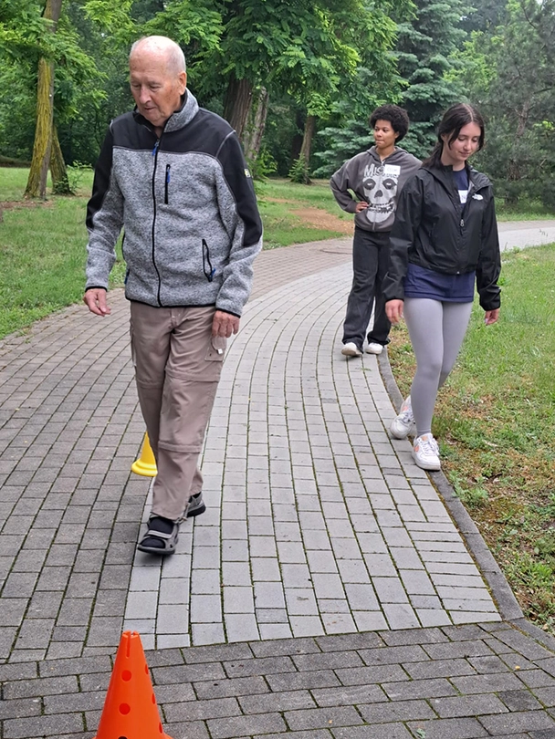 Man geht durch Parcours, Schüler begleiten ihn